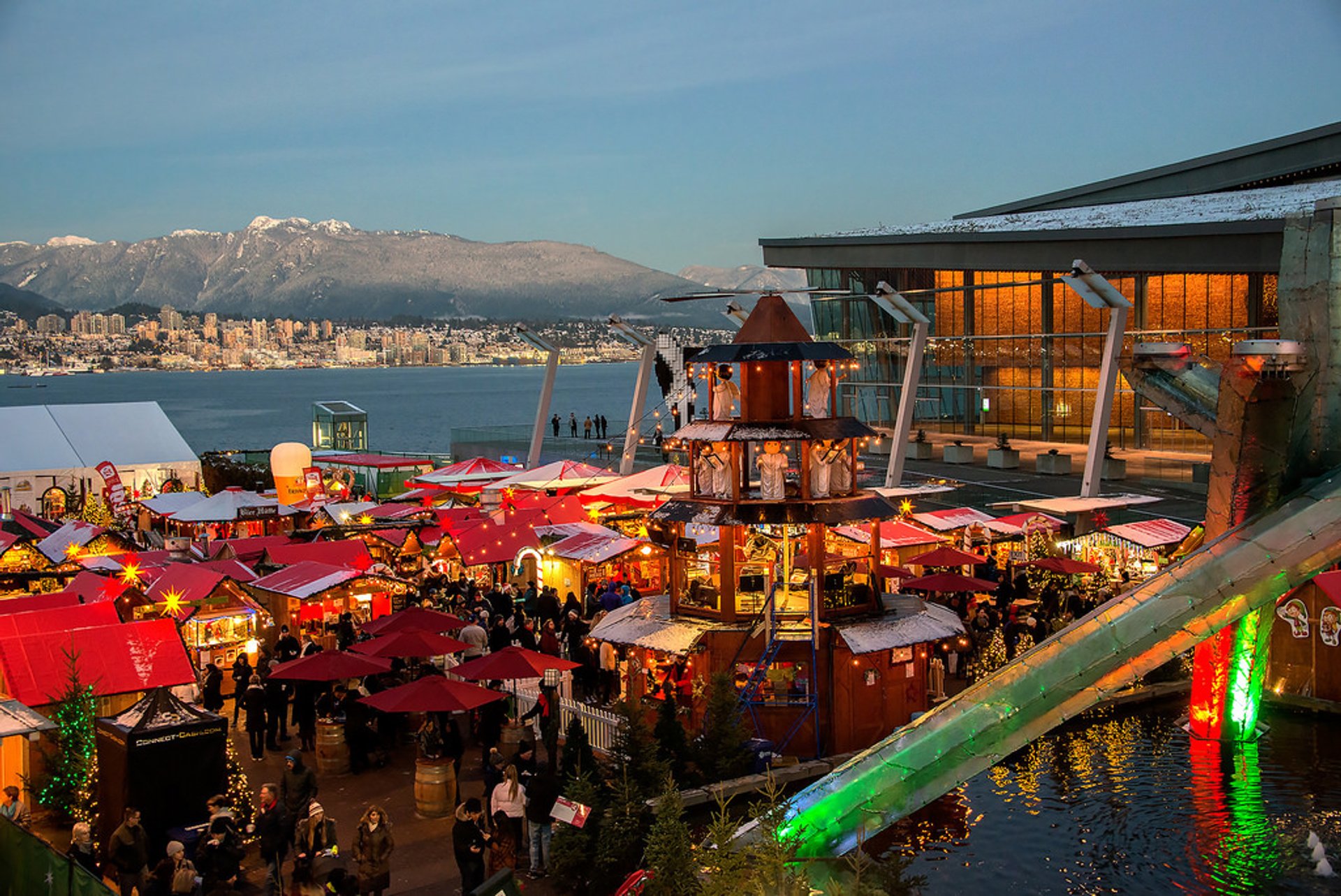 Vancouver Christmas Market illuminated at dusk beside the harbour